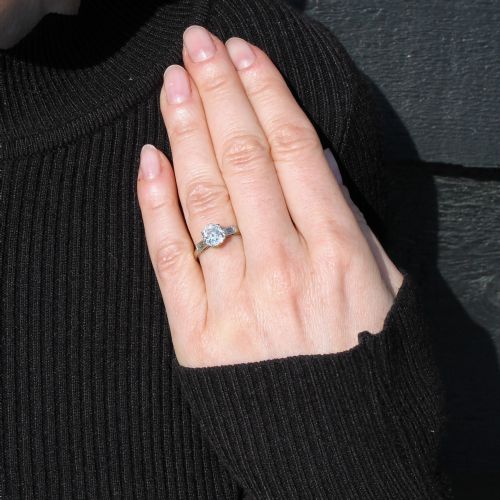 fig 1. An Art Deco platinum engagement ring featuring a central round old cut diamond flanked by two rectangular baguette diamonds.