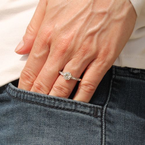 fig 1. An Art Deco diamond engagement ring featuring a central round old cut diamond flanked by diamond-set shoulders on a silver-coloured metal band.