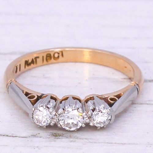 fig 2. A mid-century three-stone diamond ring crafted with an 18ct yellow gold shank and platinum settings.