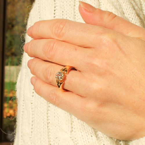 fig 1. A mid-century yellow gold solitaire ring featuring a single round old-cut diamond held in a claw setting with sculpted shoulders.