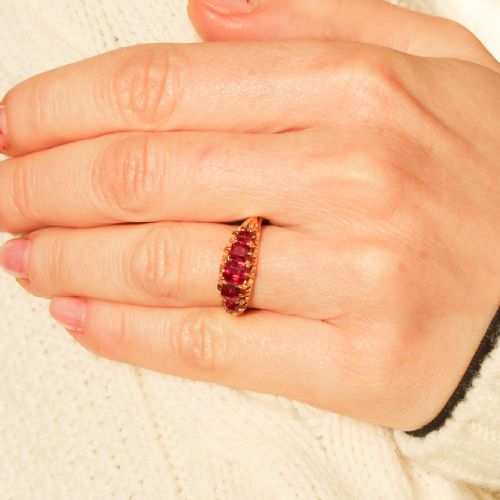 fig 1. A Victorian yellow gold ring set with five graduated cushion-cut red rubies in a carved claw setting.