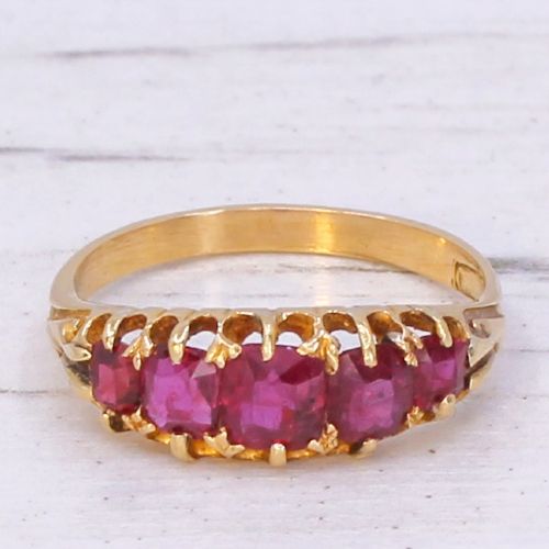 fig 2. A Victorian yellow gold ring set with five graduated cushion-cut red rubies in a carved claw setting.