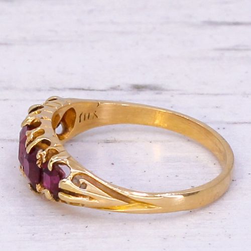 fig 3. A Victorian yellow gold ring set with five graduated cushion-cut red rubies in a carved claw setting.