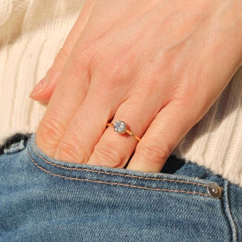 fig 1. An Art Deco diamond solitaire engagement ring with an old cut diamond set in white metal claws on a yellow gold band.