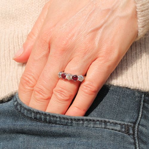 fig 1. A mid-century white metal five stone ring set with alternating round red rubies and old cut white diamonds.