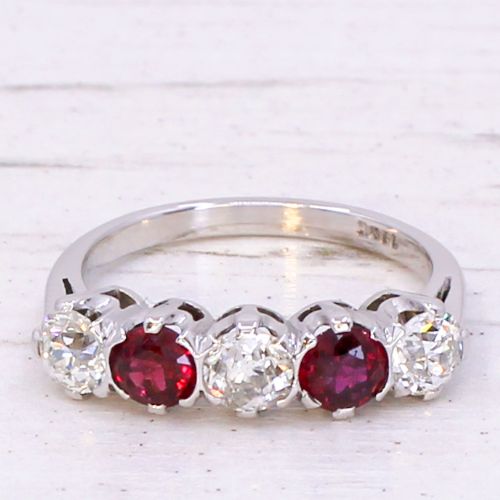 fig 2. A mid-century white metal five stone ring set with alternating round red rubies and old cut white diamonds.