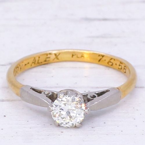 fig 2. A mid-century engagement ring featuring a single old-cut diamond set in platinum shoulders on a yellow gold band.