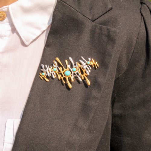 fig 1. An abstract 1960s bi-metal gold brooch featuring molten openwork structures set with circular turquoise cabochons.