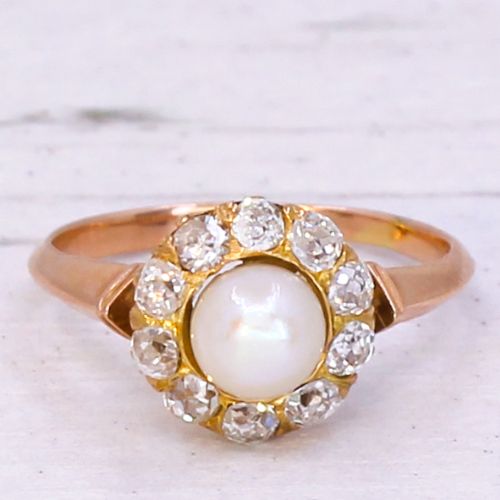fig 2. An Art Deco gold ring featuring a central white pearl surrounded by a circular halo of old cut diamonds.