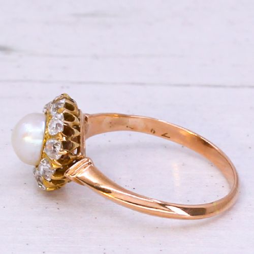 fig 3. An Art Deco gold ring featuring a central white pearl surrounded by a circular halo of old cut diamonds.