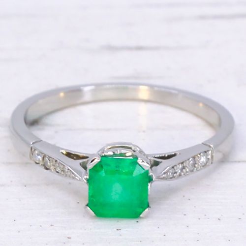 fig 2. An Art Deco ring featuring a square-cut green emerald solitaire set in a platinum band with small diamond shoulders.