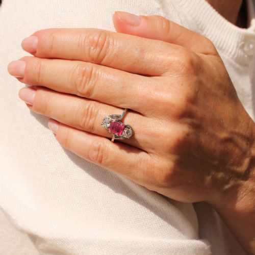 fig 1. An Art Deco platinum ring featuring a central rectangular pink-red ruby flanked by round and baguette cut diamonds in an asymmetric setting.