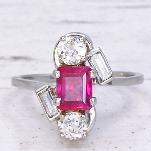 fig 2. An Art Deco platinum ring featuring a central rectangular pink-red ruby flanked by round and baguette cut diamonds in an asymmetric setting.