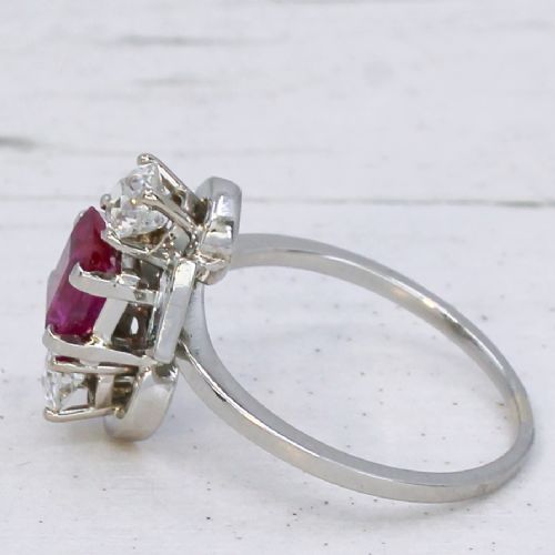 fig 3. An Art Deco platinum ring featuring a central rectangular pink-red ruby flanked by round and baguette cut diamonds in an asymmetric setting.