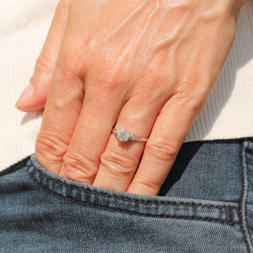 fig 1. An Art Deco platinum engagement ring featuring a central round old cut diamond set in a coronet mount with detailed diamond shoulders.