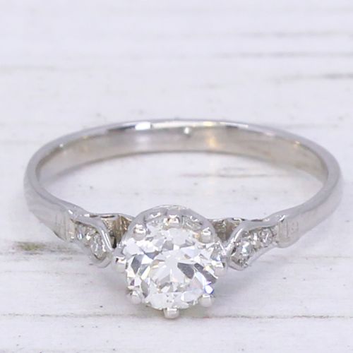 fig 2. An Art Deco platinum engagement ring featuring a central round old cut diamond set in a coronet mount with detailed diamond shoulders.