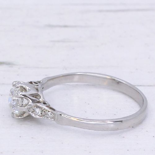 fig 3. An Art Deco platinum engagement ring featuring a central round old cut diamond set in a coronet mount with detailed diamond shoulders.
