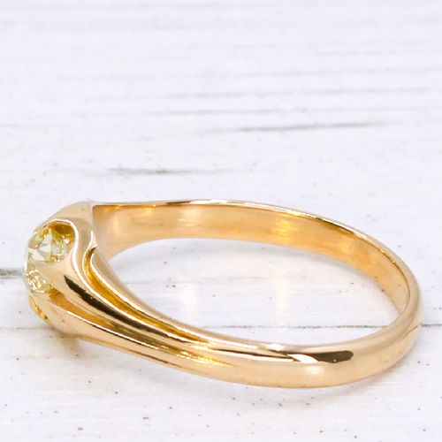 fig 3. A late Victorian yellow gold ring featuring a single central antique cut fancy yellow diamond in a carved setting.