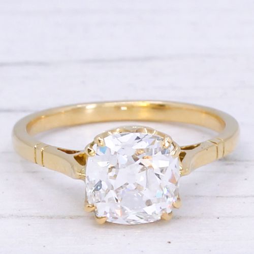 fig 2. An antique yellow gold solitaire ring featuring a cushion-shaped old cut diamond in a claw setting.
