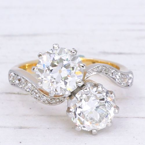 fig 2. A vintage two-stone diamond Toi et Moi ring featuring two old European cut diamonds set in claw settings with a yellow gold band and diamond-paved shoulders.