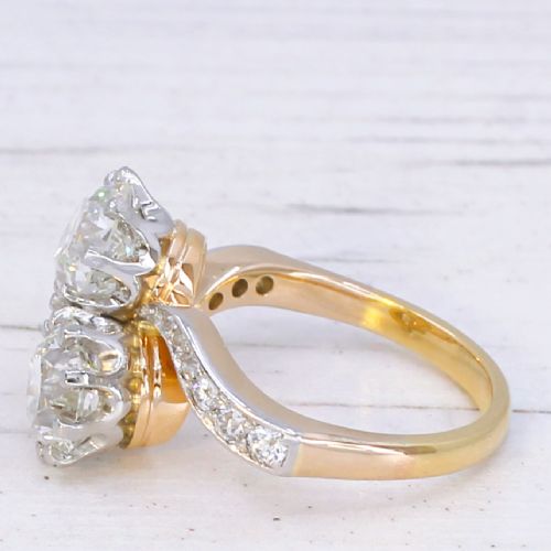 fig 3. A vintage two-stone diamond Toi et Moi ring featuring two old European cut diamonds set in claw settings with a yellow gold band and diamond-paved shoulders.