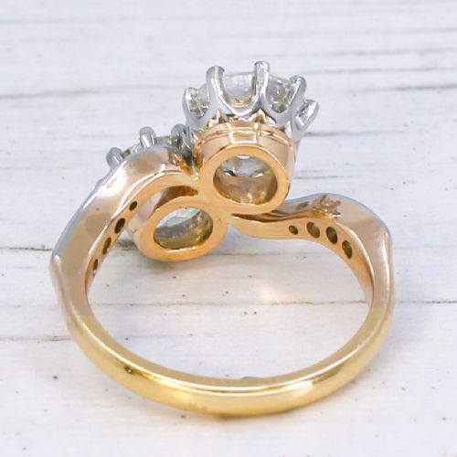 A vintage two-stone diamond Toi et Moi ring featuring two old European cut diamonds set in claw settings with a yellow gold band and diamond-paved shoulders. View V