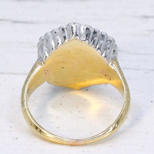 An oval blue sapphire surrounded by a double halo of diamonds set in a scalloped white metal mount on an engraved yellow gold band. View V