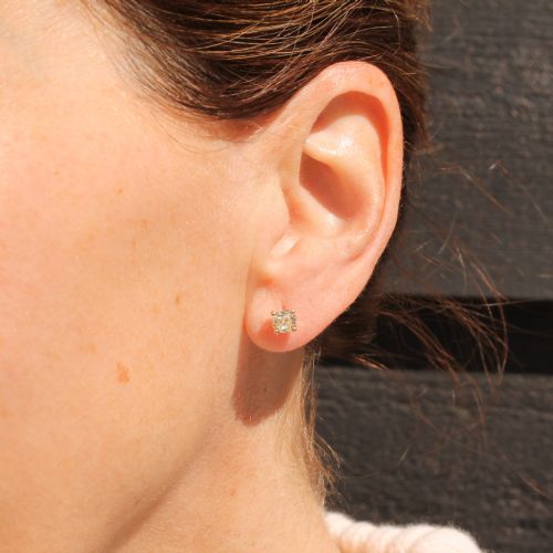 fig 1. A pair of 18k yellow gold stud earrings featuring claw-set old mine cut diamonds.