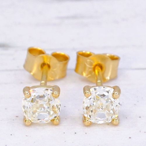 fig 2. A pair of 18k yellow gold stud earrings featuring claw-set old mine cut diamonds.