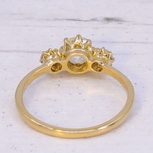 An Edwardian yellow gold trilogy ring featuring three old-cut diamonds set in claw mountings. View V