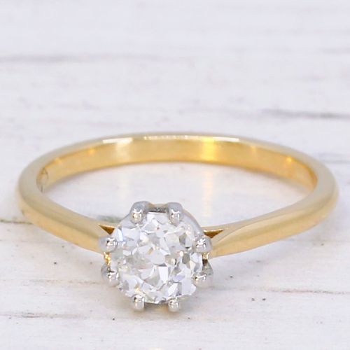 fig 2. A 1920s engagement ring featuring a single old cut diamond held in a six-claw white metal setting on a slender yellow gold band.