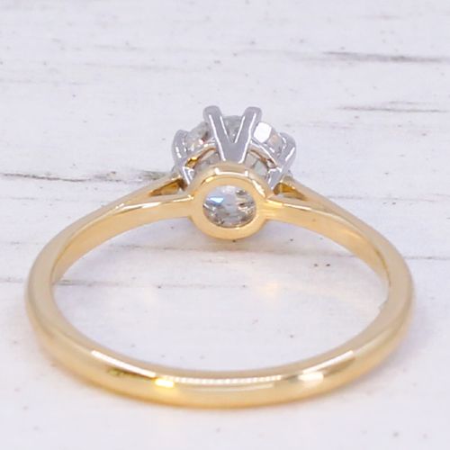 A 1920s engagement ring featuring a single old cut diamond held in a six-claw white metal setting on a slender yellow gold band. View V