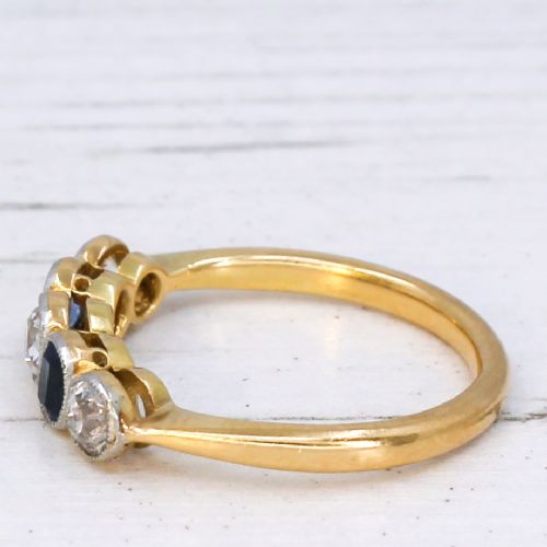 fig 3. An antique yellow gold ring set with five alternating old cut diamonds and cushion-shaped blue sapphires featuring millegrain details.