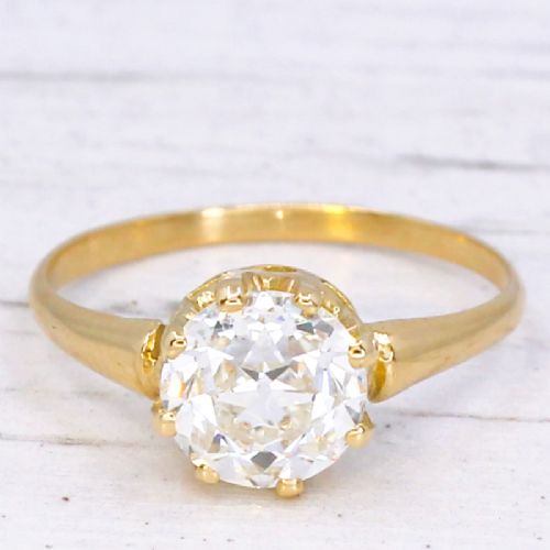 fig 2. A vintage yellow gold engagement ring featuring a prominent round old cut diamond held in a multi-claw setting.