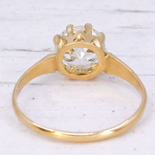 A vintage yellow gold engagement ring featuring a prominent round old cut diamond held in a multi-claw setting. View V