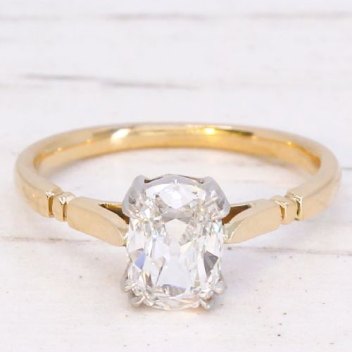 fig 2. An antique gold engagement ring featuring an old mine cut solitaire diamond held in a claw setting.