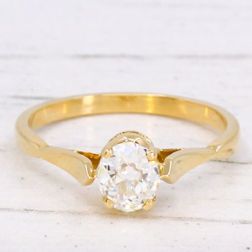 fig 2. A vintage 1930s yellow gold ring featuring a central claw-set oval cut diamond with tapered shoulders.
