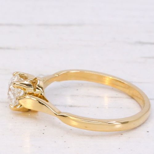 fig 3. A vintage 1930s yellow gold ring featuring a central claw-set oval cut diamond with tapered shoulders.