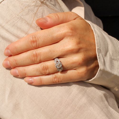 fig 1. An Art Deco diamond ring featuring a central old cut diamond set in platinum with leaf-motif shoulders on an 18ct yellow gold band.