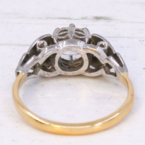 fig 4. An Art Deco diamond ring featuring a central old cut diamond set in platinum with leaf-motif shoulders on an 18ct yellow gold band.