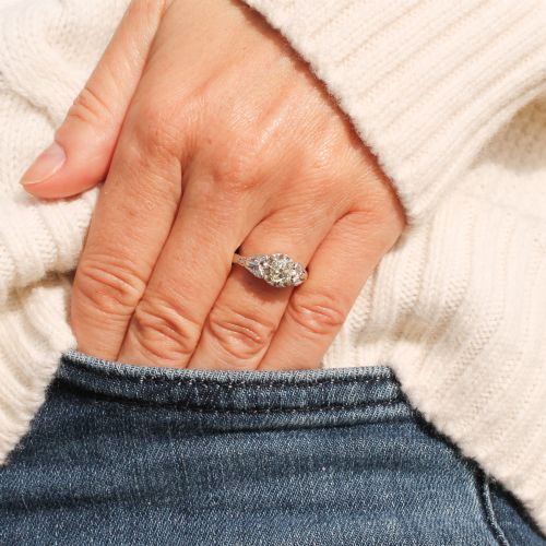 fig 1. An Art Deco style white metal ring featuring a central old European cut diamond set in an ornate pierced basket setting.