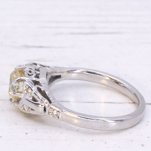 fig 3. An Art Deco style white metal ring featuring a central old European cut diamond set in an ornate pierced basket setting.
