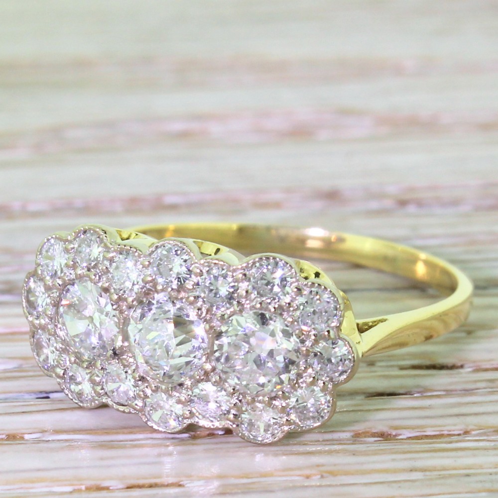 Mid Century 2.07 Carat Old Cut Diamond Triple Daisy Cluster Ring, circa 1950
