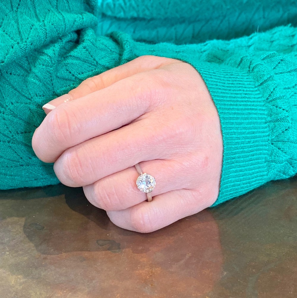 An Art Deco platinum solitaire ring featuring a round old European cut diamond secured in a claw setting. View VII