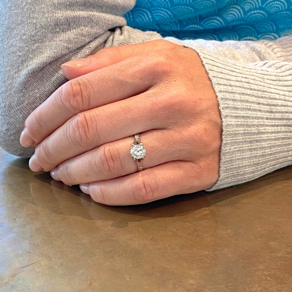 An Art Deco platinum engagement ring featuring a central old cut diamond in a claw setting with split shoulders. View VIII