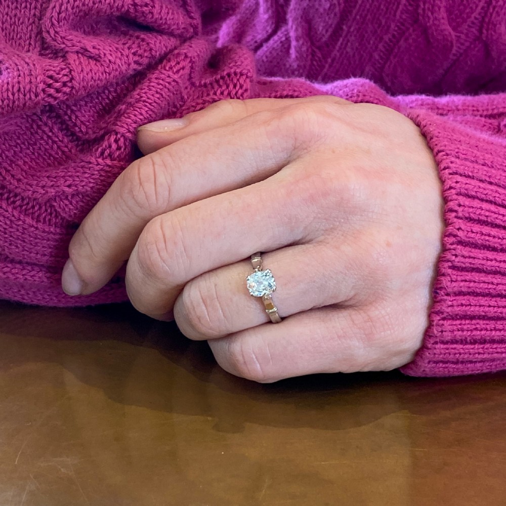 An Art Deco diamond engagement ring featuring a central cushion-shaped old cut diamond set in platinum with detailed shoulders. View VIII