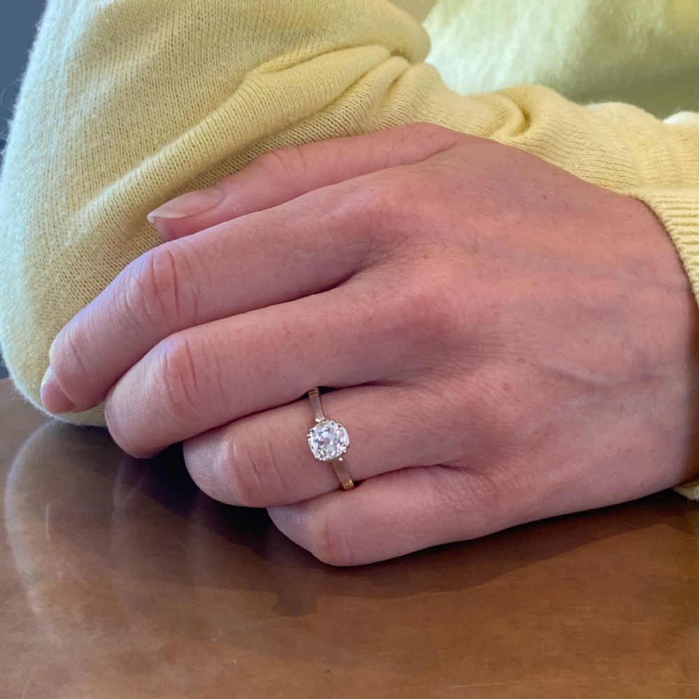 An Art Deco diamond engagement ring featuring a central round old cut diamond in a multi-claw platinum setting on a yellow gold band. View VIII