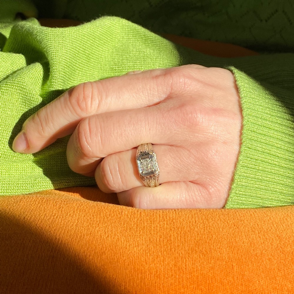 A mid-century white metal ring featuring a central old cut diamond set within an octagonal head and intricately engraved shoulders. View VIII