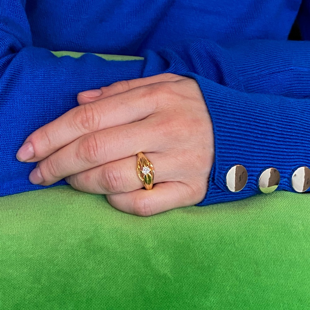 A late Victorian yellow gold ring featuring a central old cut diamond set between split shoulders. View VII