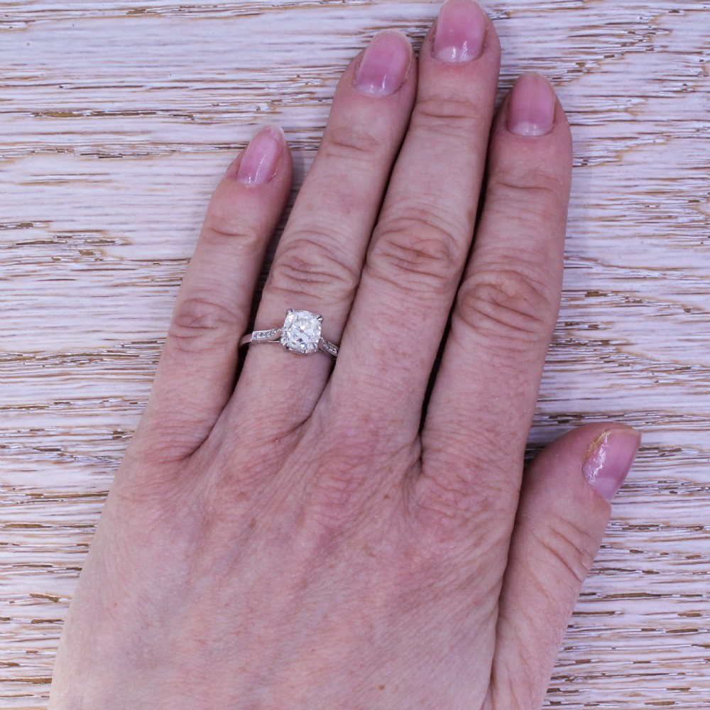 An Art Deco platinum engagement ring set with a central old cut diamond held in claw settings with delicate millegrain shoulders. View VI